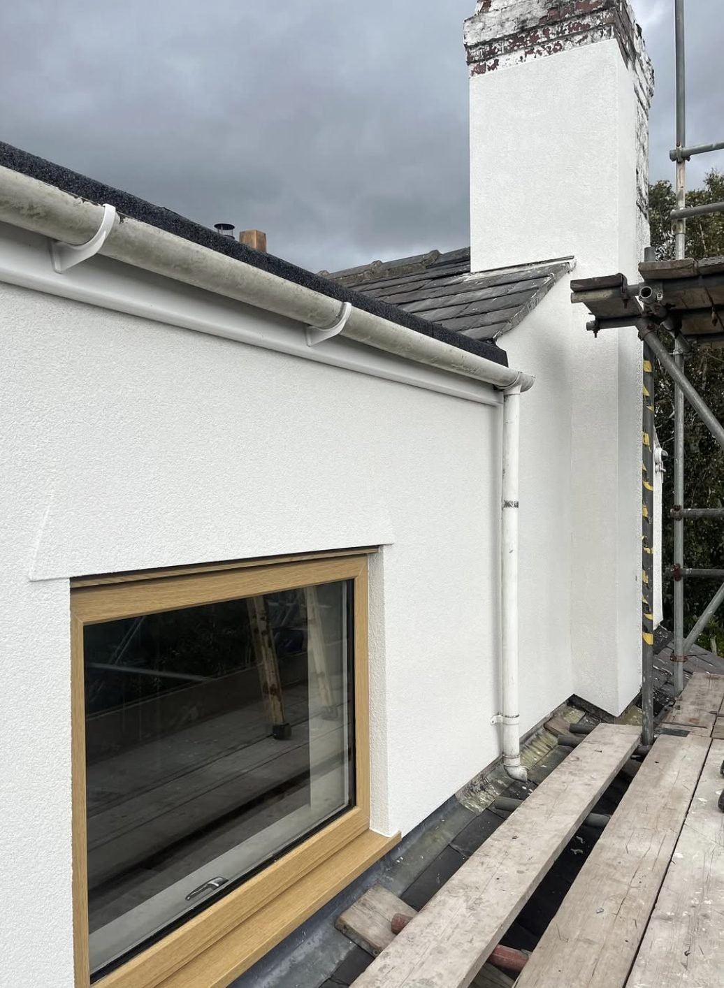 Chimney stack and dormer rendered at high level from the scaffold