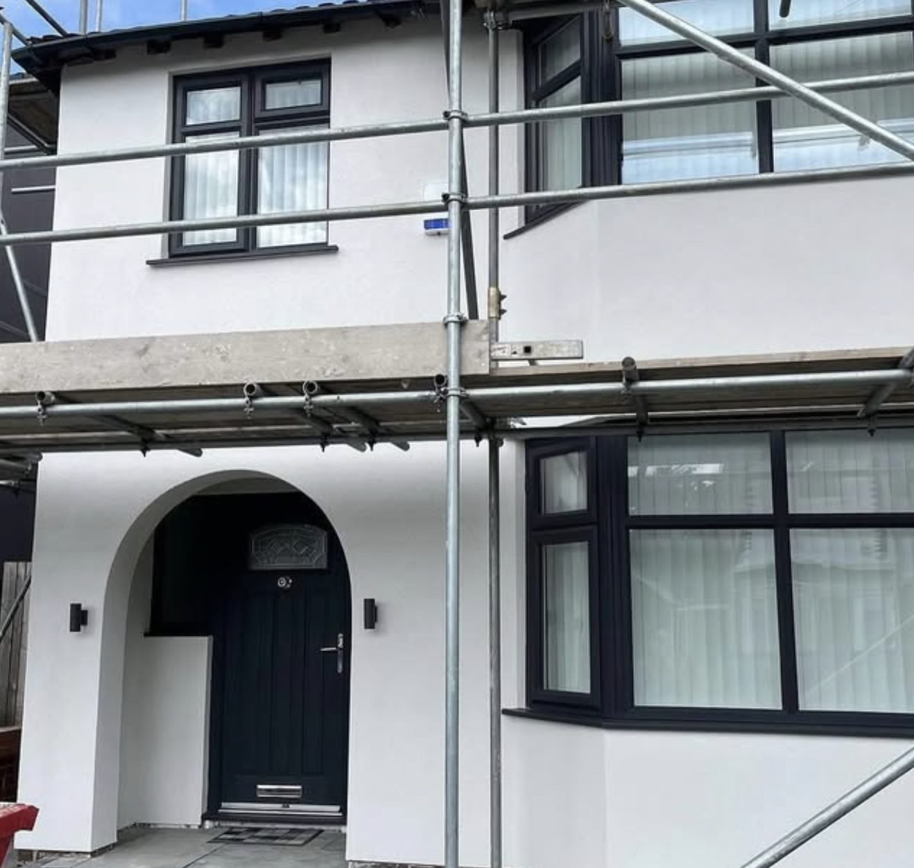 Semi-detached house mid-job with the scaffold still standing